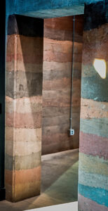 A photo of an interior rammed earth walkthrough.